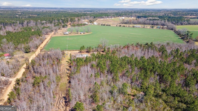 drone / aerial view featuring a rural view and a wooded view