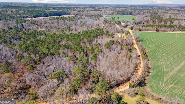 birds eye view of property featuring a forest view