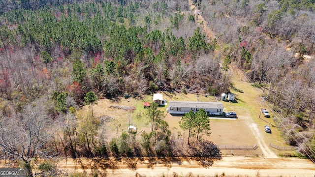 birds eye view of property with a view of trees