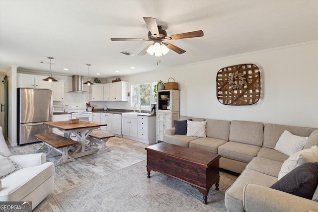 living room featuring recessed lighting, visible vents, a ceiling fan, and crown molding