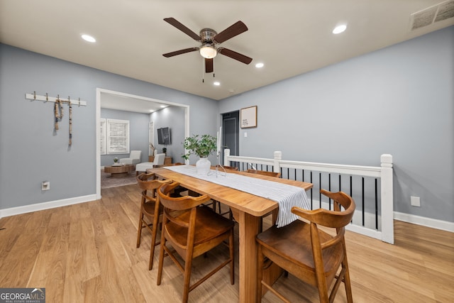 dining space with light wood finished floors, recessed lighting, visible vents, a ceiling fan, and baseboards