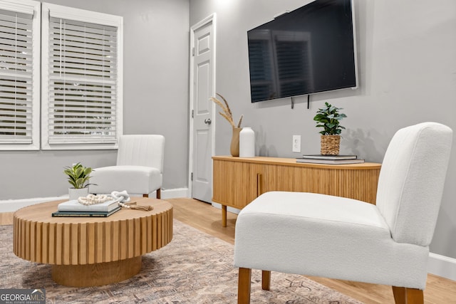 sitting room featuring baseboards and wood finished floors