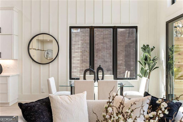 dining area featuring wood finished floors and a decorative wall