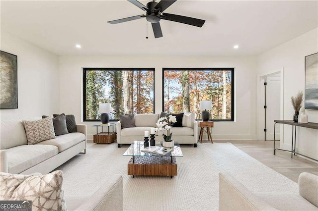 living room with baseboards, a ceiling fan, and recessed lighting