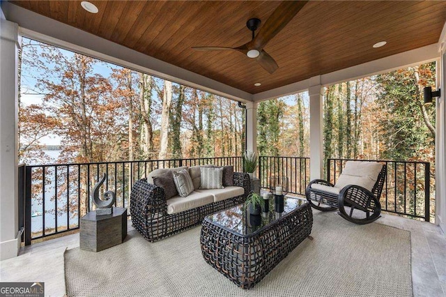 sunroom / solarium featuring wooden ceiling and ceiling fan