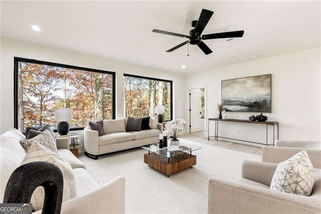 living room with wood finished floors, a ceiling fan, and recessed lighting