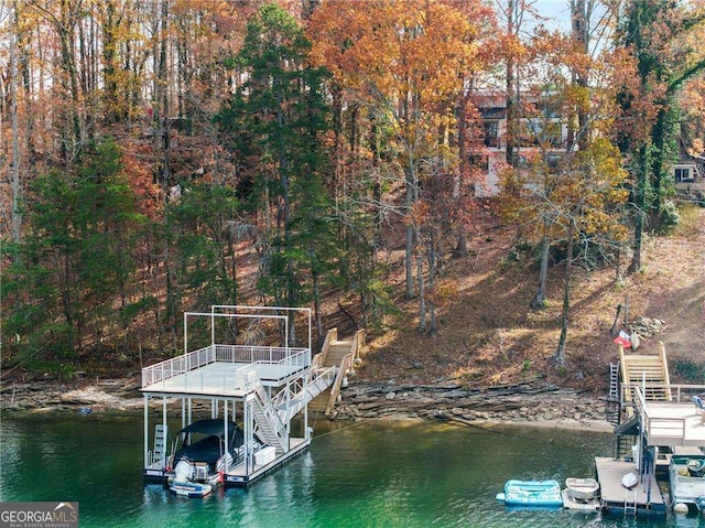 dock area with stairway and a water view