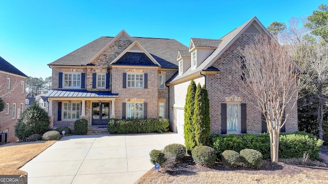 view of front of property featuring driveway, cooling unit, and brick siding