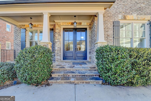 doorway to property featuring french doors and brick siding