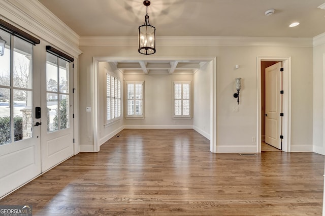 foyer with crown molding, baseboards, coffered ceiling, and wood finished floors