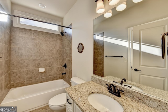 bathroom featuring toilet,  shower combination, and vanity