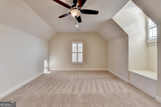 bonus room featuring lofted ceiling, a healthy amount of sunlight, visible vents, and carpet flooring