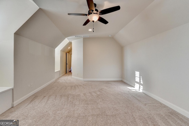 additional living space with vaulted ceiling, ceiling fan, carpet flooring, and baseboards