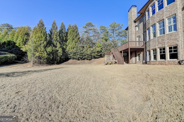 view of yard featuring a deck and stairway