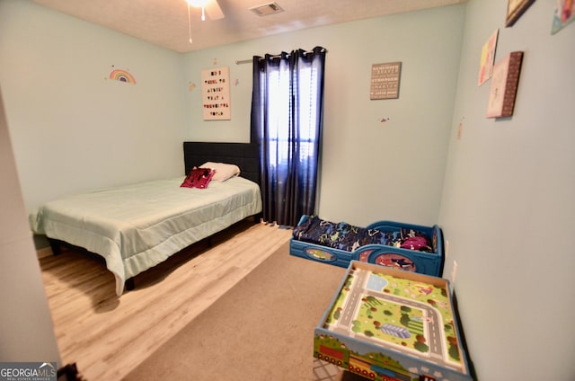 bedroom with visible vents and wood finished floors