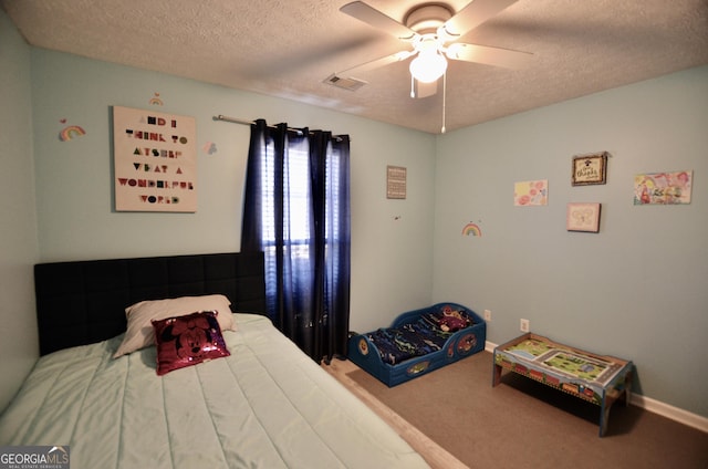 carpeted bedroom featuring baseboards, ceiling fan, visible vents, and a textured ceiling