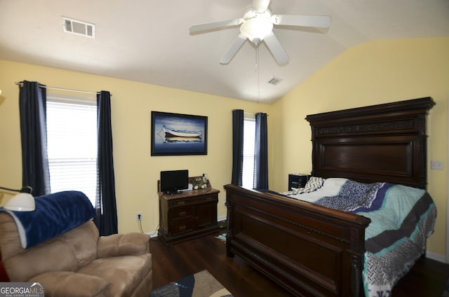 bedroom featuring ceiling fan, visible vents, vaulted ceiling, and dark wood finished floors