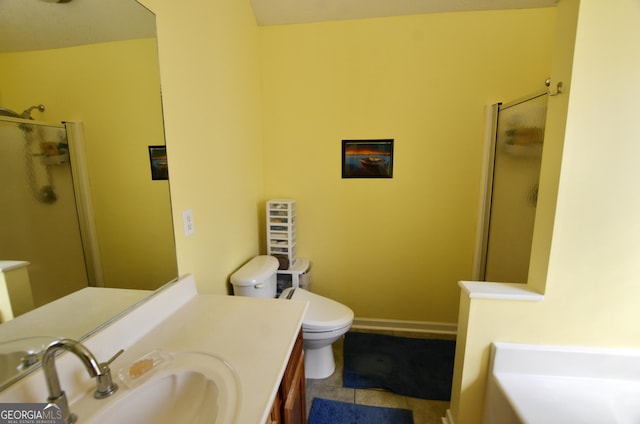 bathroom with toilet, a shower stall, vanity, tile patterned flooring, and baseboards