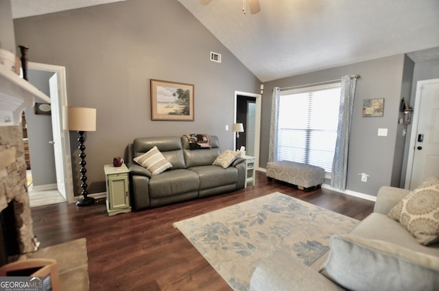 living area with dark wood-type flooring, visible vents, a fireplace, and baseboards