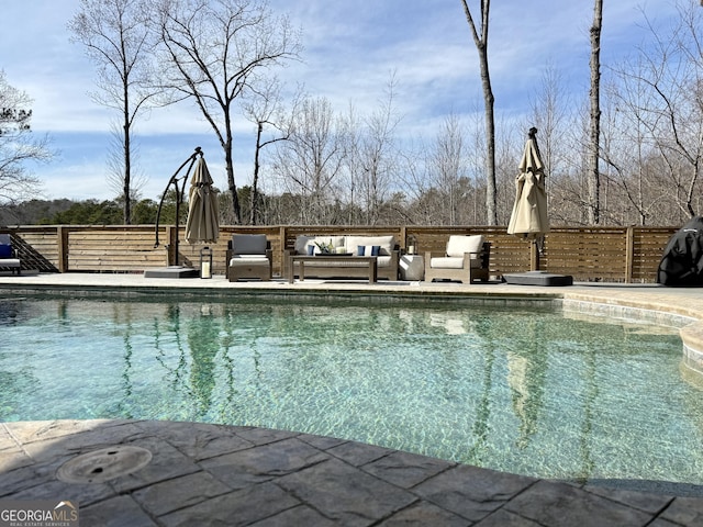 view of swimming pool featuring a fenced in pool, outdoor lounge area, and a patio