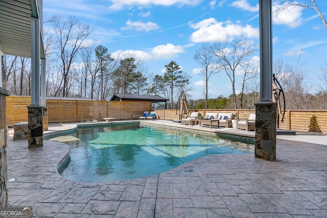 view of swimming pool featuring a fenced in pool, fence, an outdoor structure, outdoor lounge area, and a patio