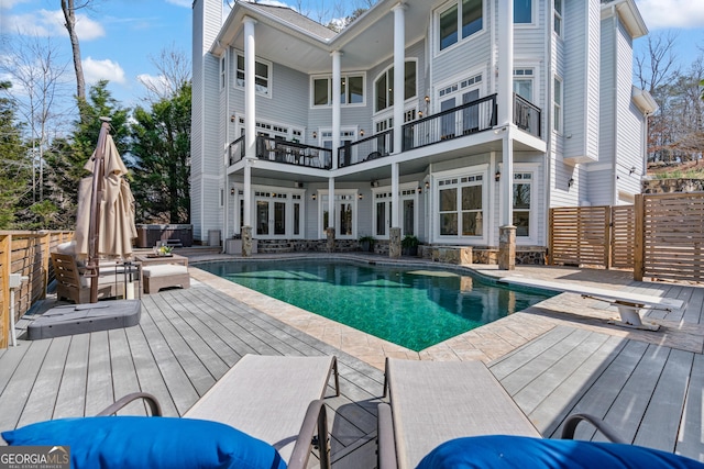 view of pool with fence, a deck, french doors, and a fenced in pool