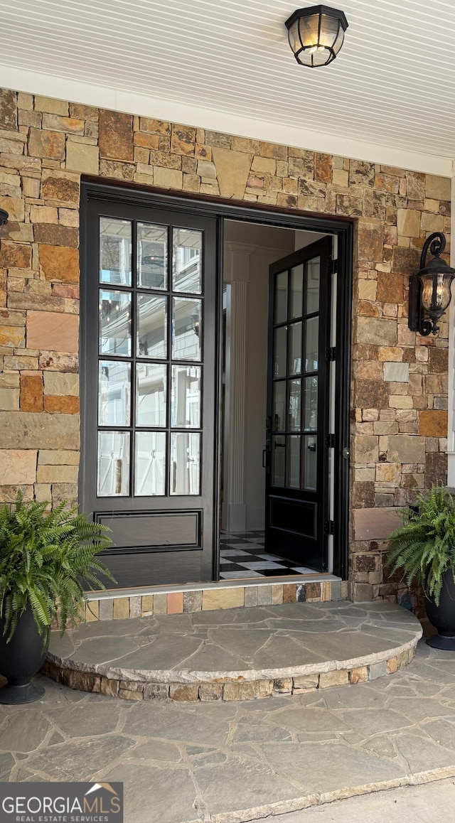 entrance to property featuring stone siding