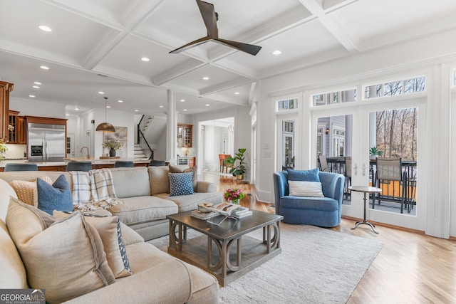 living room with coffered ceiling, stairway, a ceiling fan, light wood-type flooring, and recessed lighting