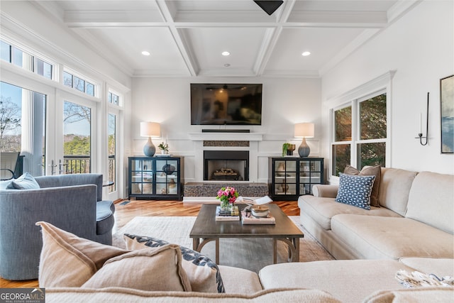 living room featuring a fireplace, wood finished floors, ornamental molding, beam ceiling, and coffered ceiling
