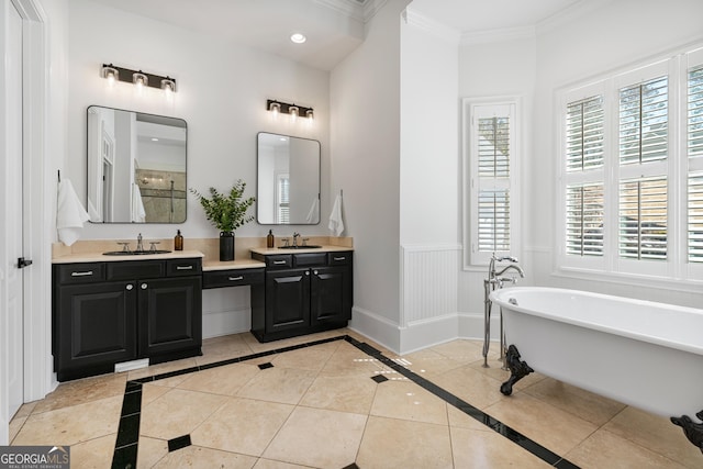 full bathroom featuring crown molding, baseboards, a wainscoted wall, tile patterned floors, and a freestanding bath