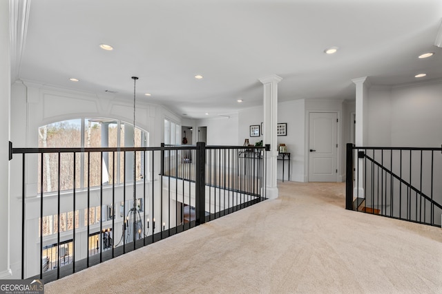 corridor featuring recessed lighting, crown molding, an upstairs landing, and carpet
