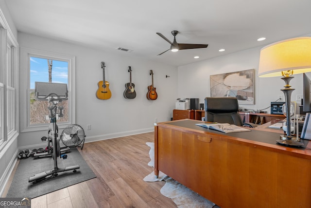 office space featuring visible vents, baseboards, recessed lighting, a ceiling fan, and light wood-type flooring