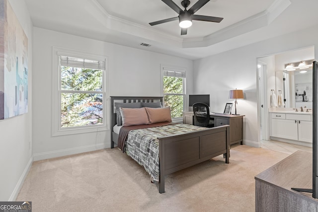 bedroom with light carpet, baseboards, crown molding, and a raised ceiling