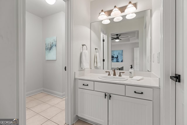 bathroom featuring baseboards, tile patterned flooring, vanity, and a ceiling fan