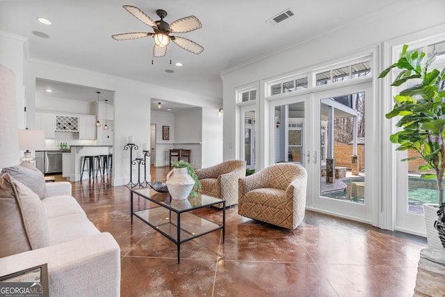 living area with visible vents, ornamental molding, french doors, and a ceiling fan