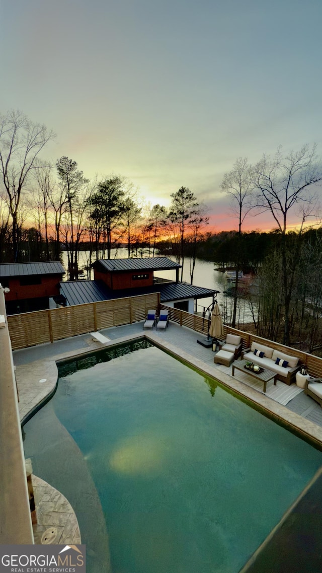 pool at dusk with an outdoor pool