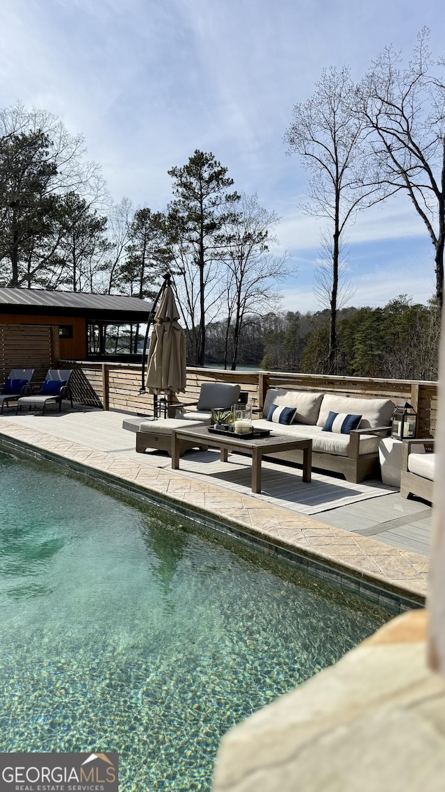 pool with outdoor lounge area and a patio