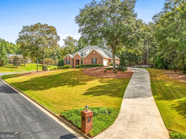 view of front of property with brick siding and a front yard