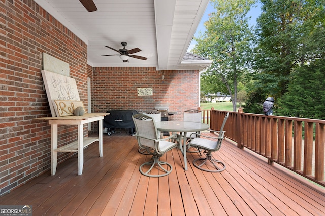 deck with ceiling fan and outdoor dining area