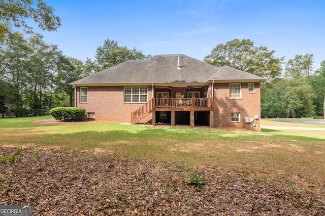 back of house featuring a deck, brick siding, a ceiling fan, stairs, and a lawn