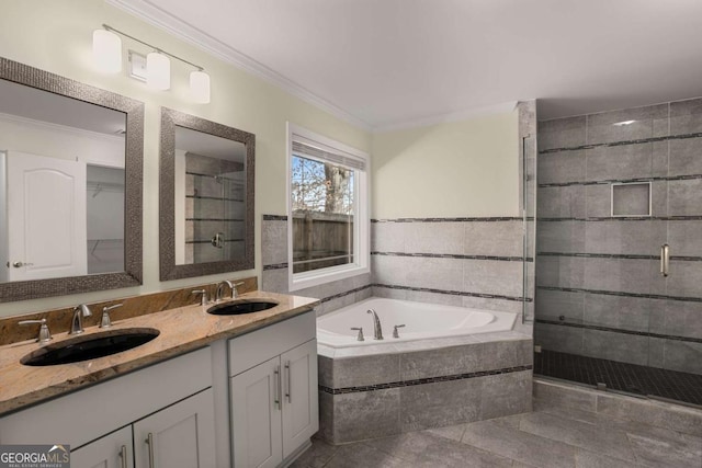 bathroom featuring a sink, a garden tub, ornamental molding, and a shower stall