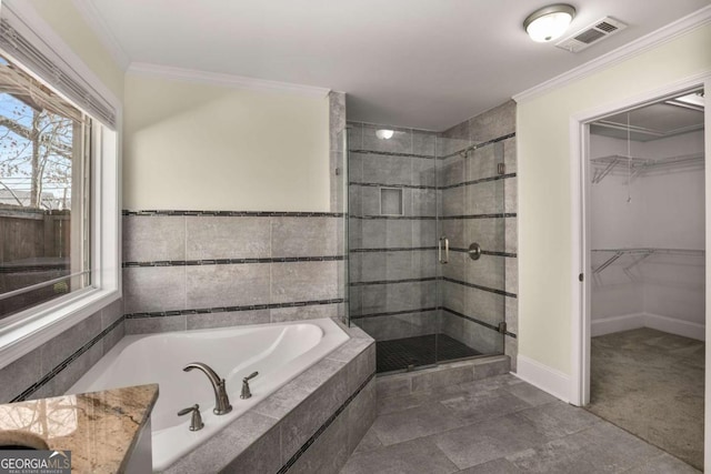 full bathroom with a walk in closet, a stall shower, visible vents, and ornamental molding