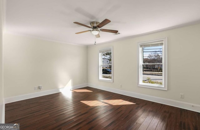 spare room featuring visible vents, crown molding, baseboards, and wood-type flooring