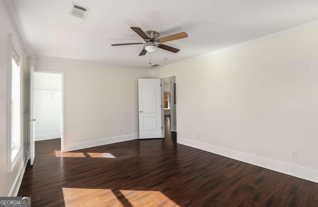 unfurnished bedroom with visible vents, crown molding, ceiling fan, dark wood-type flooring, and baseboards