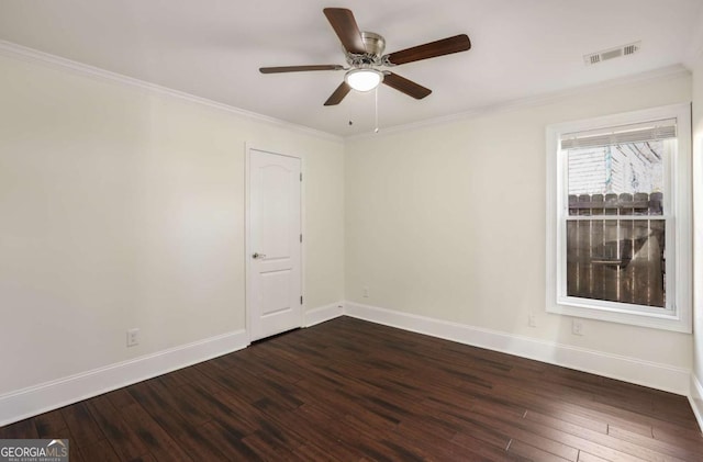 spare room featuring dark wood finished floors, baseboards, and visible vents