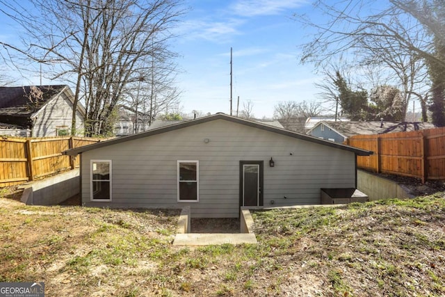 back of property featuring a patio and fence