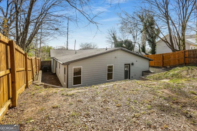 back of property featuring a fenced backyard