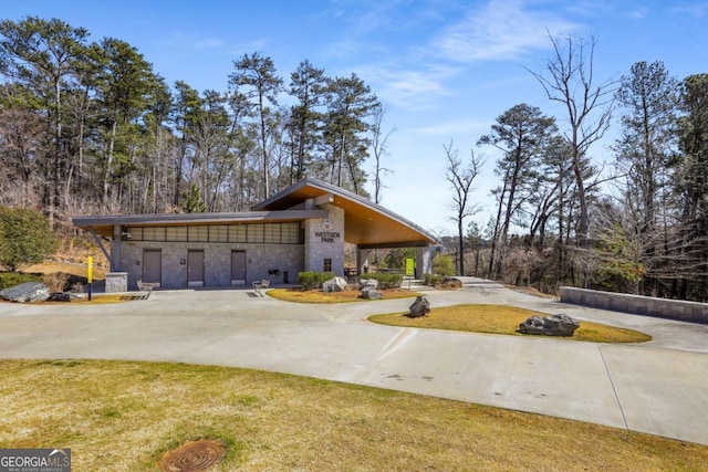 view of front of property with stone siding and a front lawn