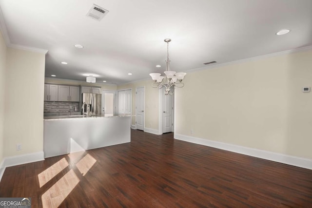 interior space featuring dark wood finished floors, visible vents, and crown molding