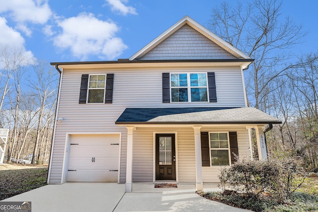 view of front facade with a garage, driveway, a porch, and a shingled roof